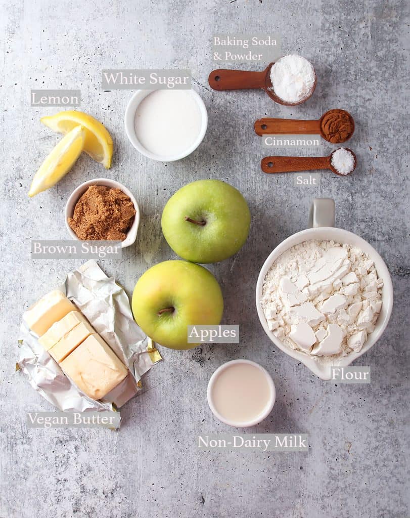 Ingredients for apple cobbler measured out and on a concrete countertop