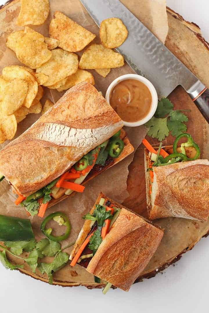 Tofu Banh mi sandwich on a platter with chips