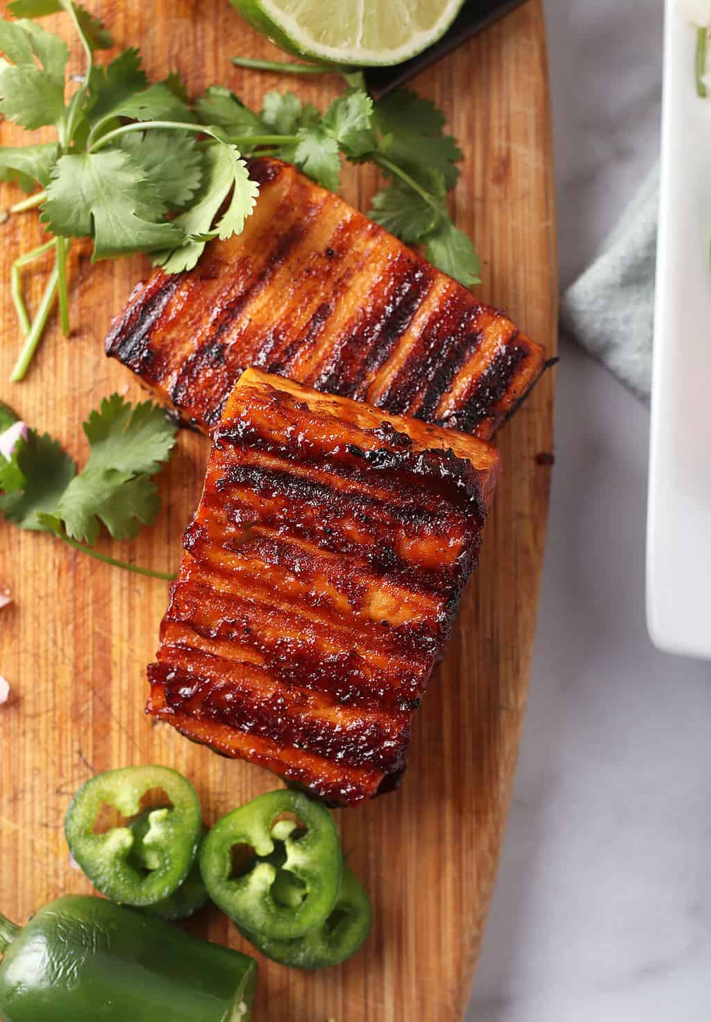 Grilled tofu steaks on wooden cutting board