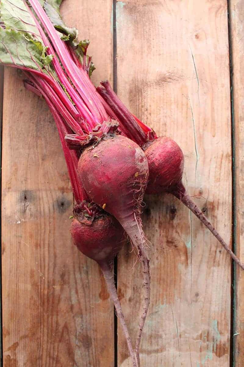 Three beets on wooden backdrop
