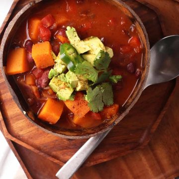 Bowl of finished chili with cilantro and avocado
