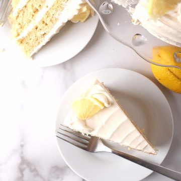 Two slices of lemon cake on white plates
