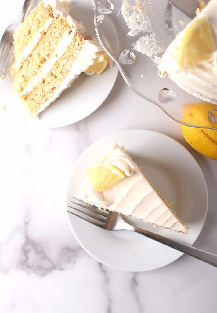 Two slices of vanilla cake on white plates