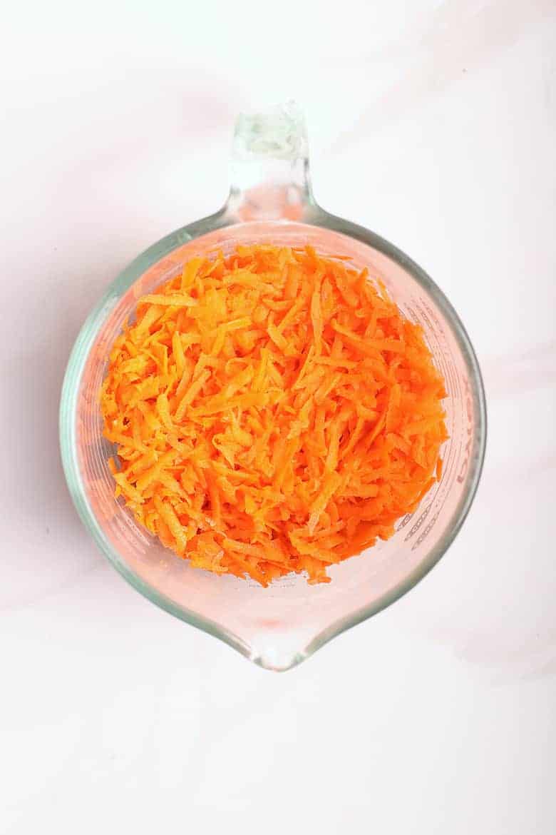 Shredded carrots in a measuring cup