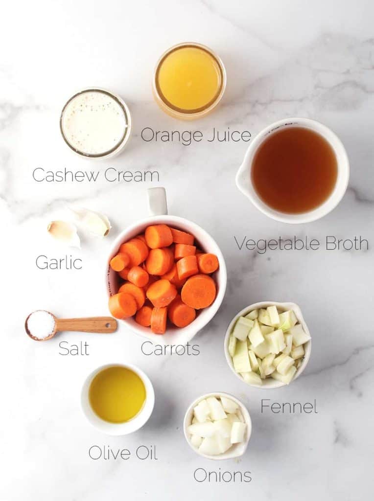 Ingredients for carrot soup on a marble background