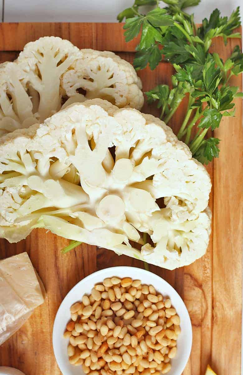 Two cauliflower pieces with pine nuts and parsley 