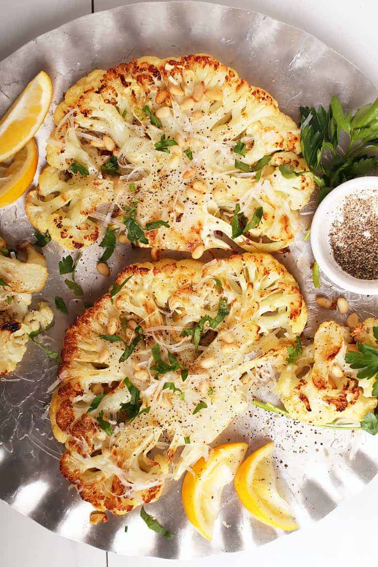 Cauliflower steaks with parmesan and pinenuts