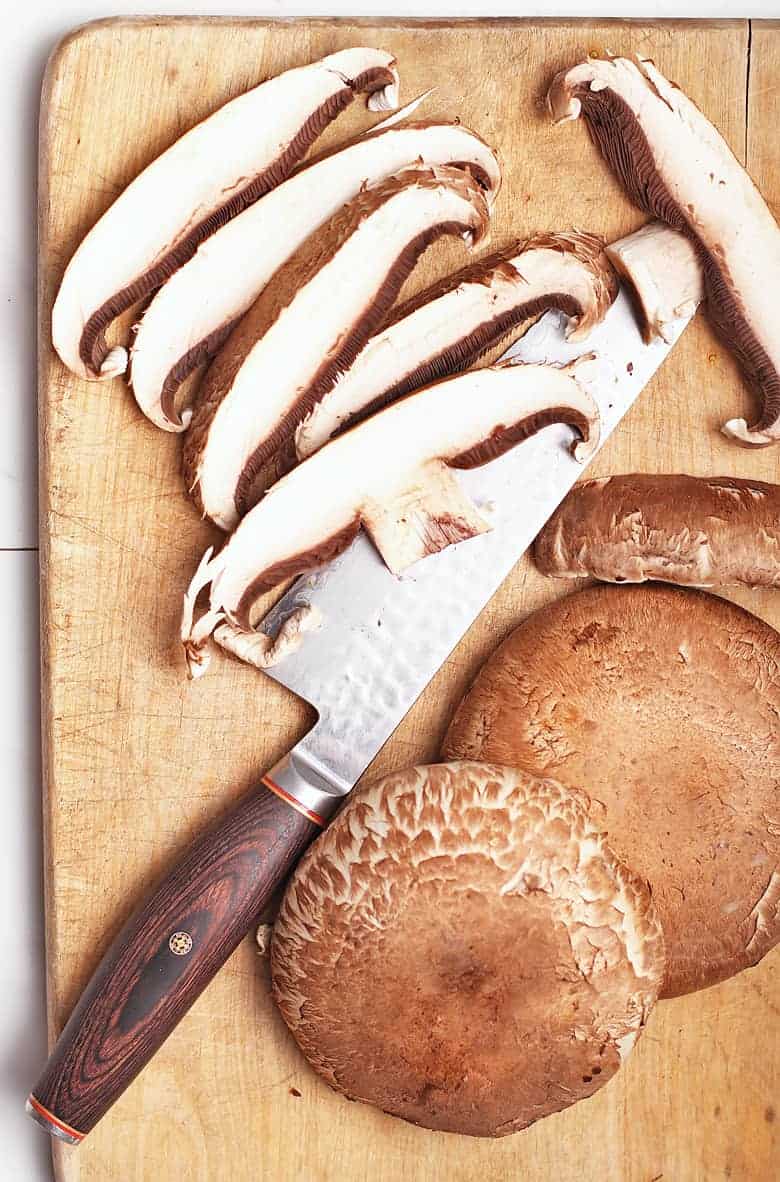 Sliced portobello mushrooms on cutting board