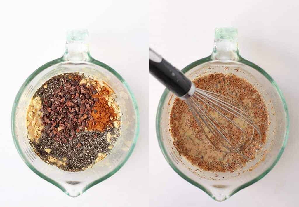 Chia seeds, cacao nibs, and milk in a liquid measuring cup