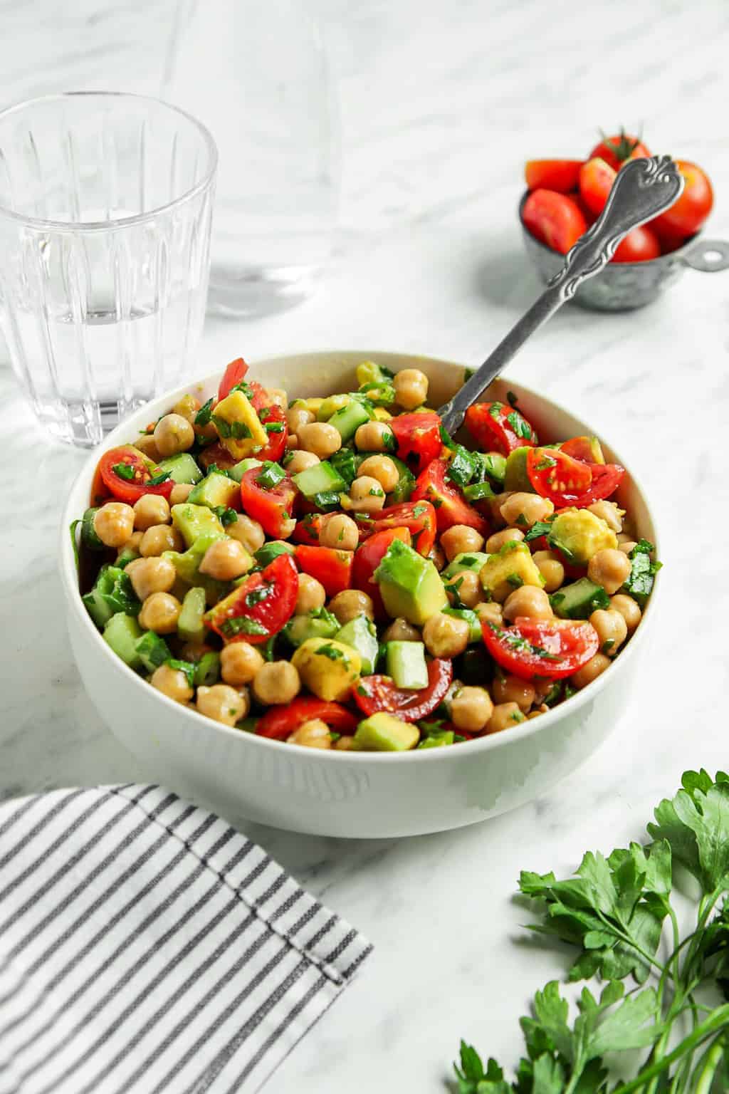 side view of chickpea salad with spoon in bowl