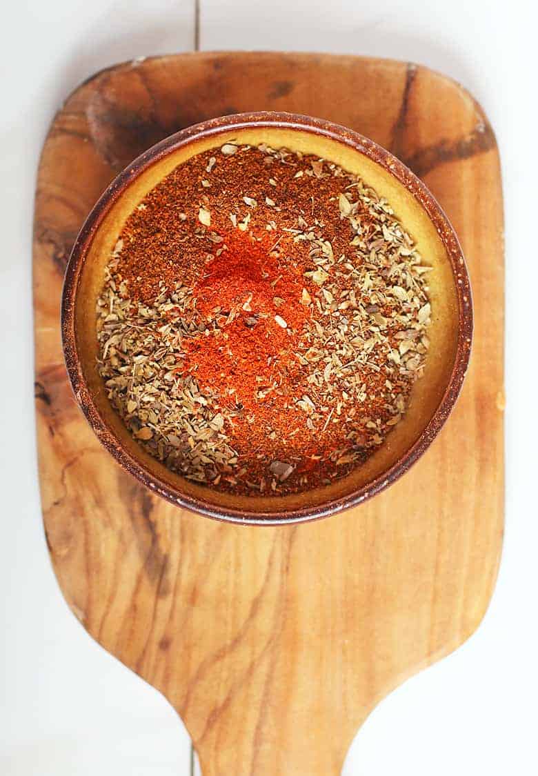 bowl of chili spices on a cutting board