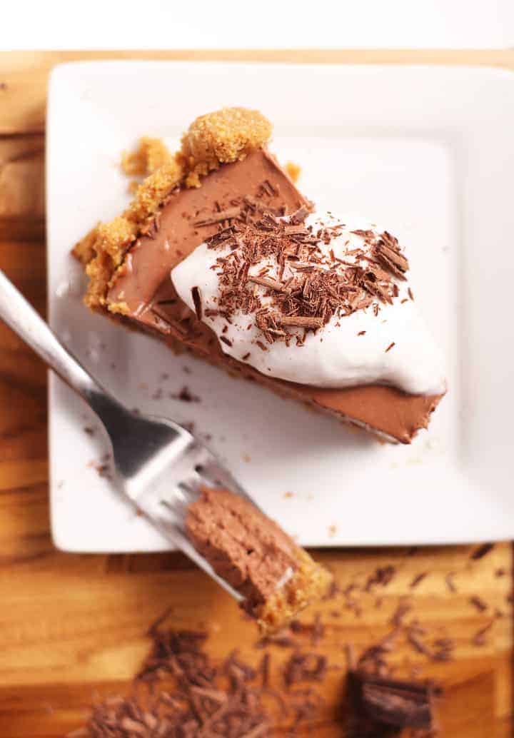 Slice of vegan chocolate pie with coconut whipped cream