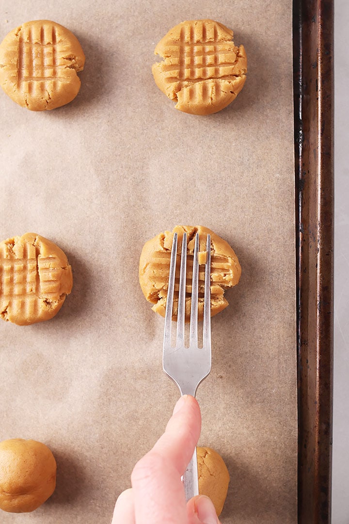 Cookies with fork pressing down dough