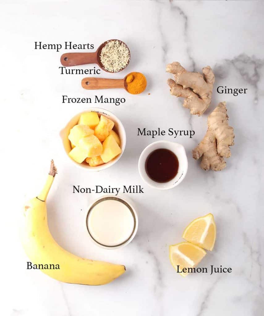 Ingredients for mango smoothie on a marble board