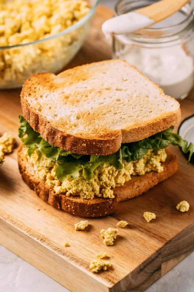 Tofu Egg Salad Sandwich on a wooden cutting board