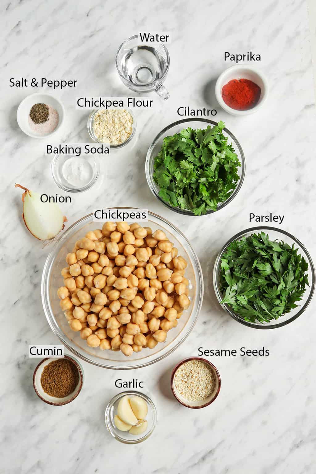 chickpeas, parsley, cilantro, sesame seeds, garlic, cumin, onion, baking soda, salt, pepper, water, chickpea flour, paprika