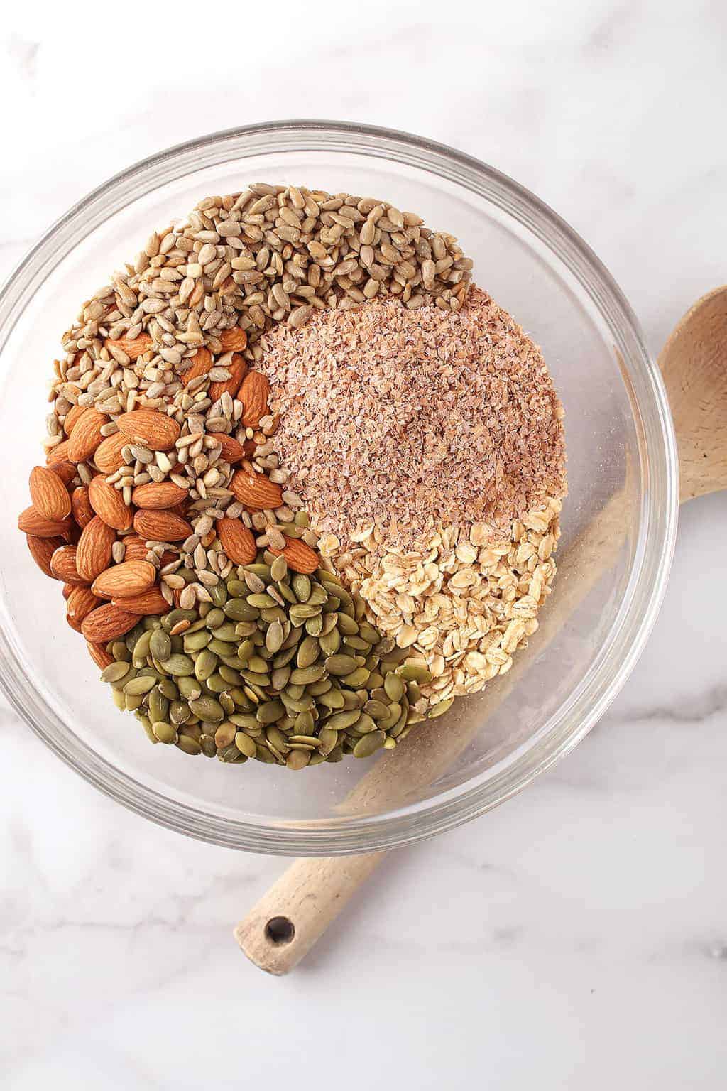 Oats, seeds, and nuts in a mixing bowl