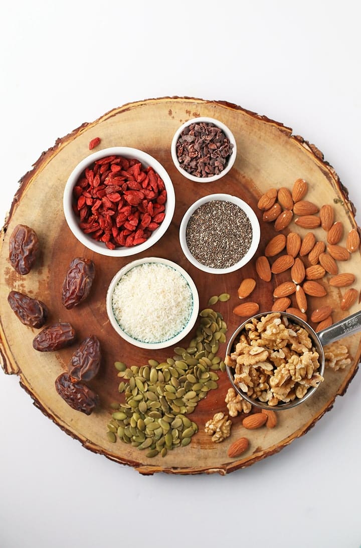 Wooden platter with a variety of nuts, seeds, and berries
