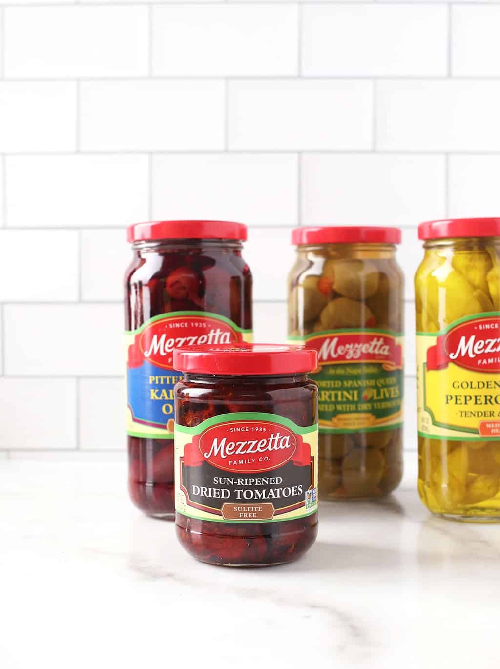 4 bottles of Mezzetta's olives and pickles