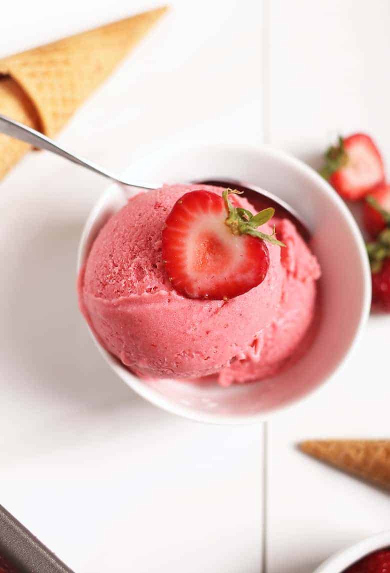 Overhead strawberry ice cream in white bowl