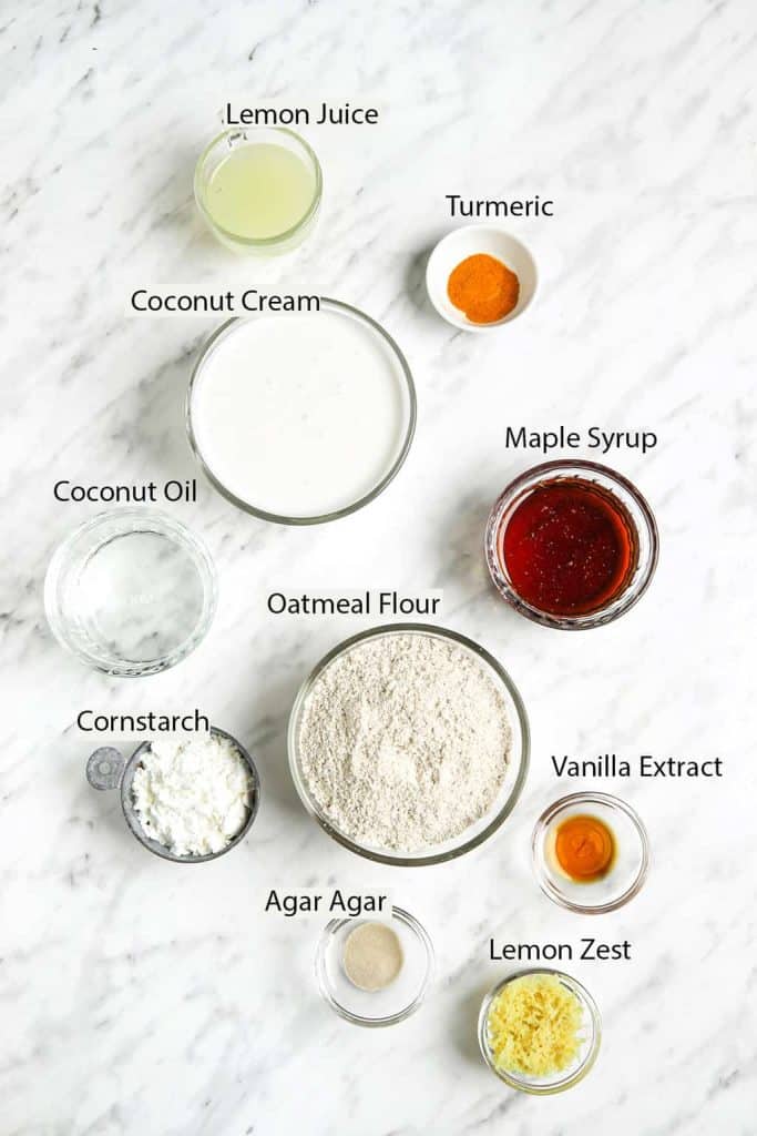 Vegan lemon tart ingredients: lemon juice, turmeric, coconut cream, maple syrup, coconut oil, oatmeal flour, cornstarch, agar agar, vanilla extract and lemon zest