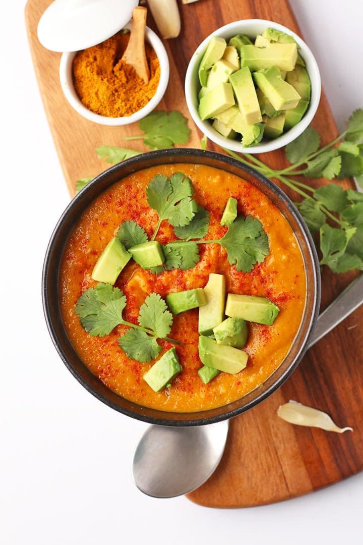 Red Lentil Soup on a wooden platter with toppings