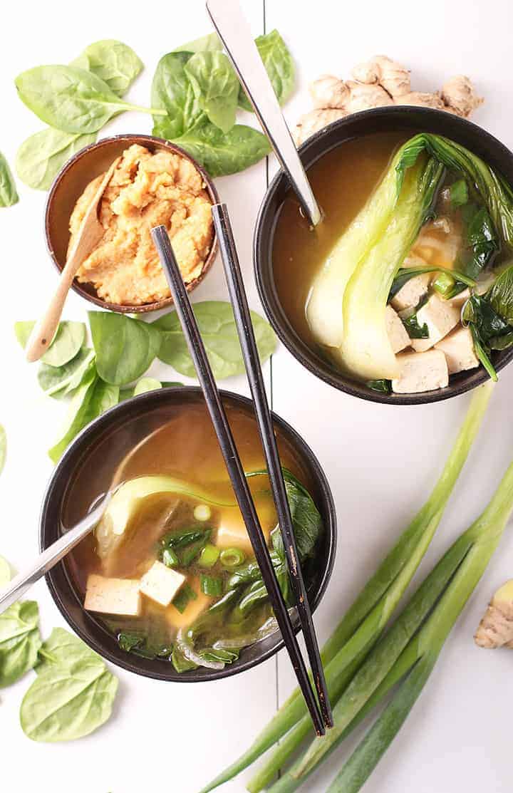 Two bowls of miso soup with chopsticks