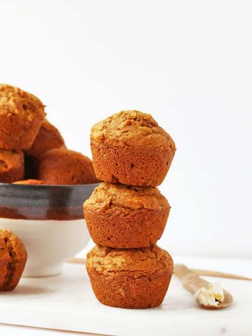 Stack of vegan muffins next to a bowl