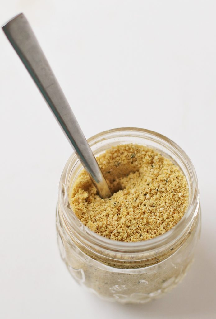 Vegan Parmesan Cheese in a glass mason jar with a spoon