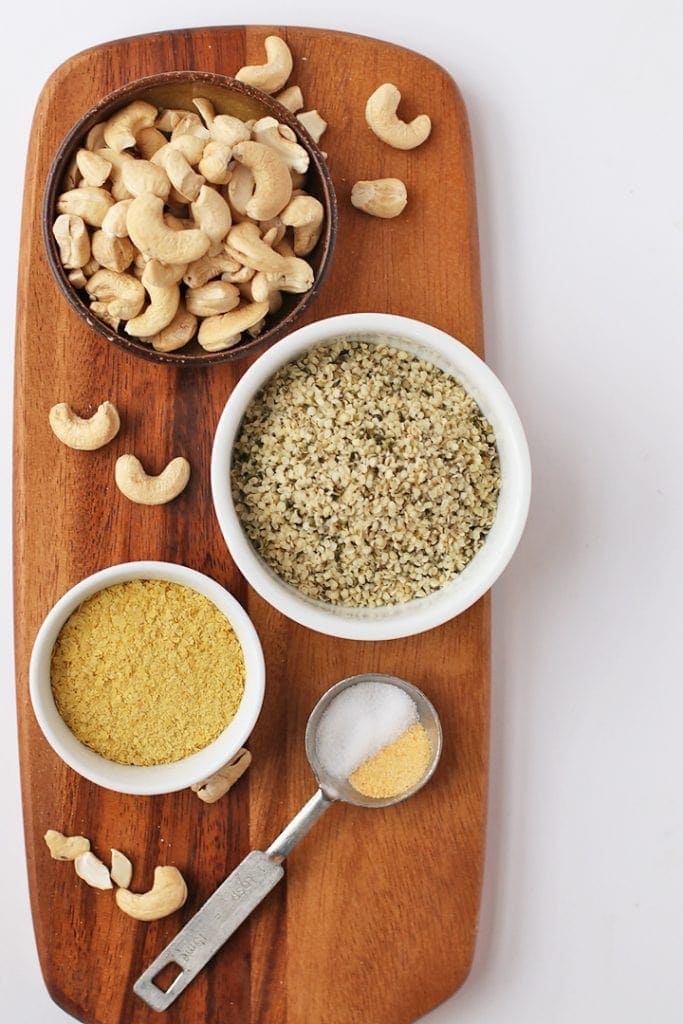Cashews, hemp hearts, and nutritional yeast on a wooden board