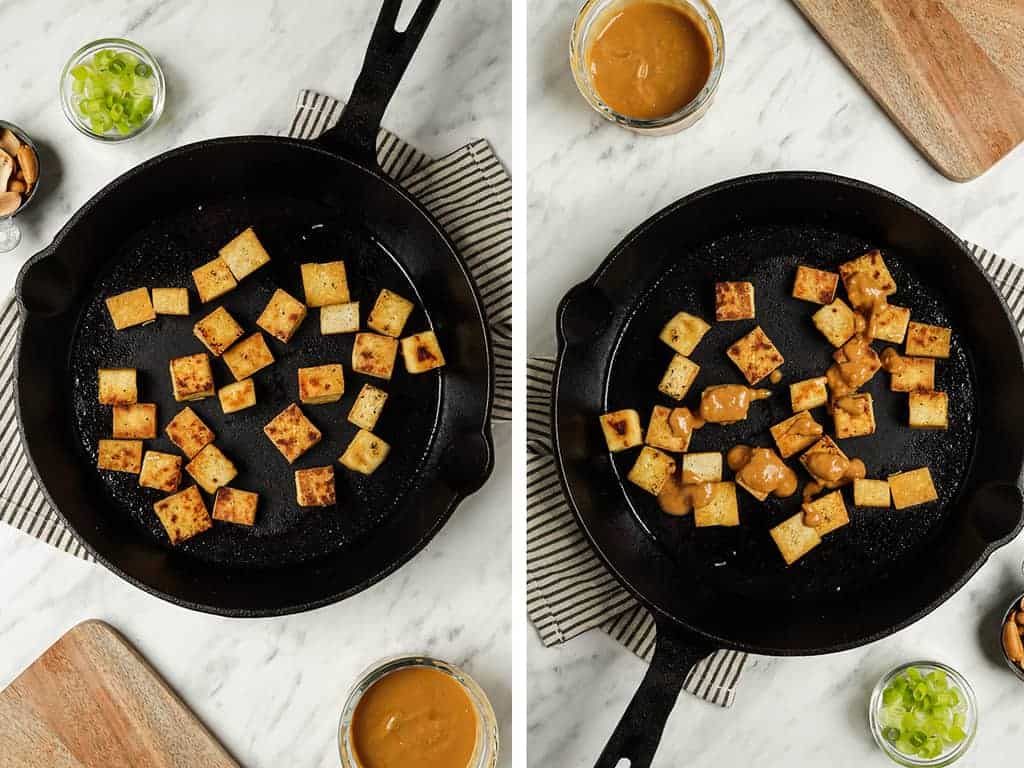 Crispy cubed tofu in a cast iron skillet drizzled with peanut sauce. 