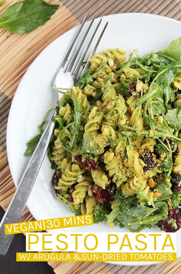 This vegan Pesto Pasta is made with arugula pesto and tossed with sun-dried tomatoes and arugula for a delicious, filling meal the whole family will love. Made in just 30 minutes for an easy weeknight meal.  #vegan #veganrecipes #vegandinner #dinner #easydinner #easyrecipes #pasta #pesto #pestopasta