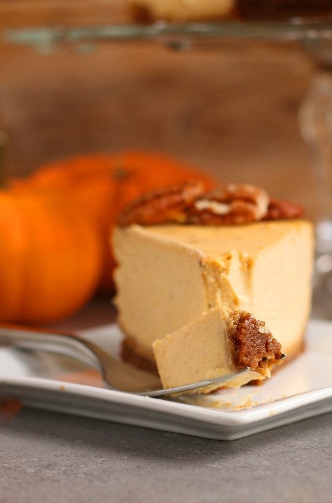 Vegan Pumpkin Cheesecake on a white plate with a fork