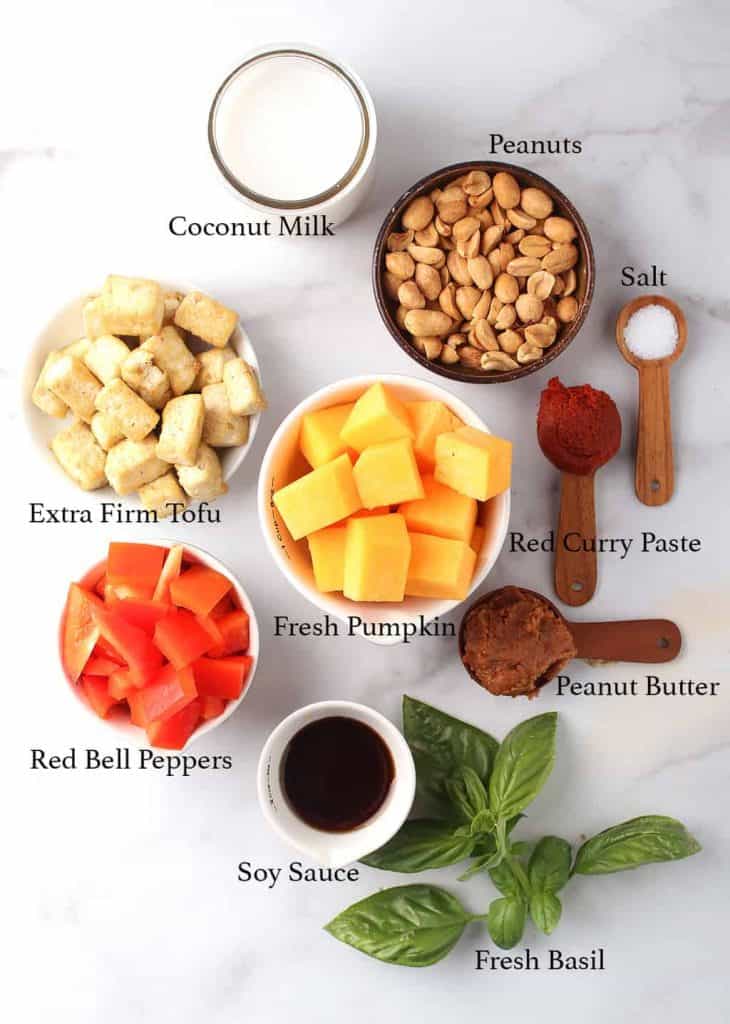 Ingredients for vegan pumpkin curry on a marble countertop
