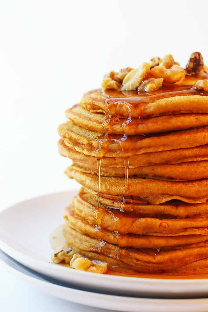 Close of up pumpkin pancakes with candied walnuts and maple syrup