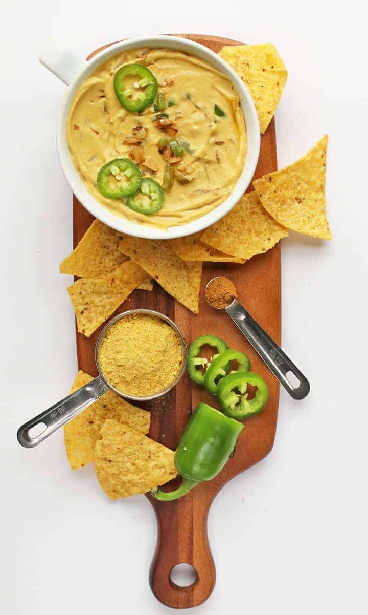 Finished recipe on a wooden board with tortilla chips