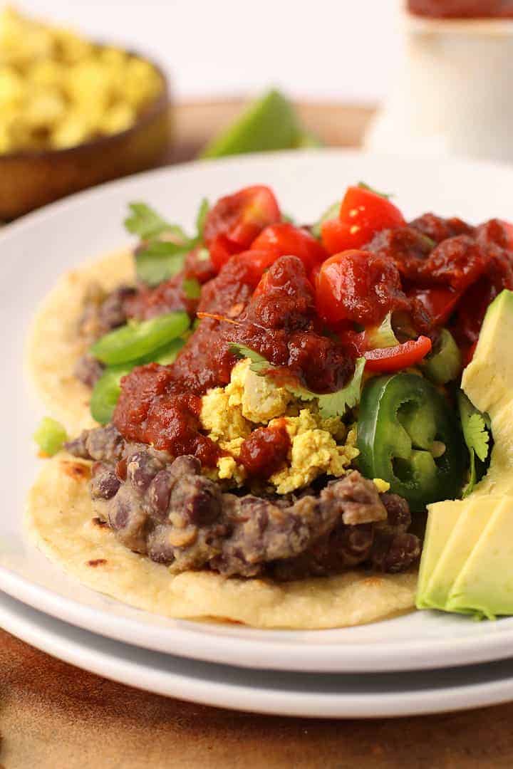 Refried beans and scrambled tofu on crispy tortillas