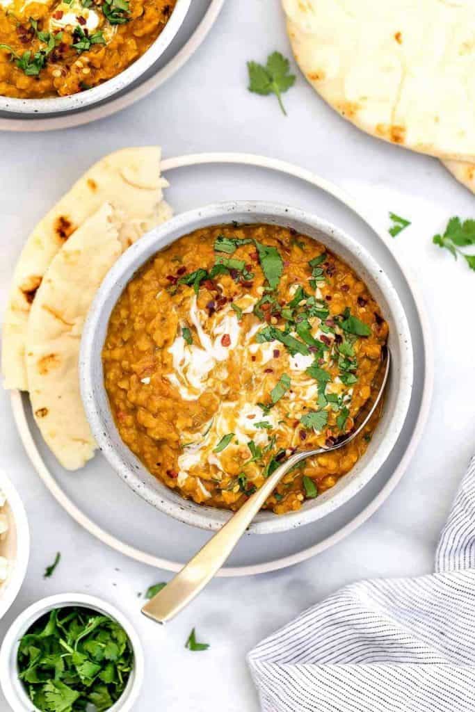 Bowl of red lentil curry with flatbread