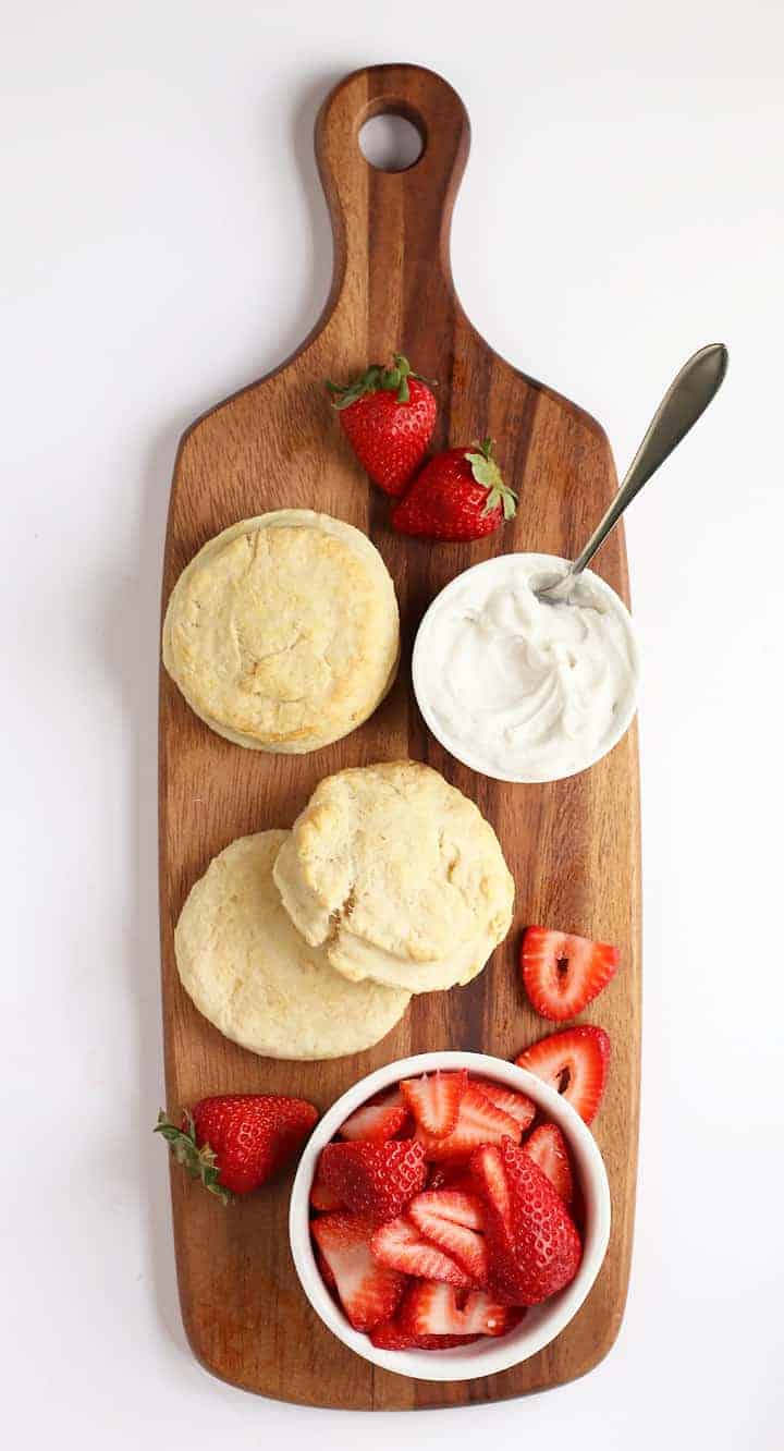 Ingredients for Strawberry Shortcakes on a wooden platter
