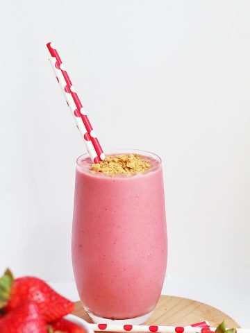 Finished smoothie in a large glass with a red straw