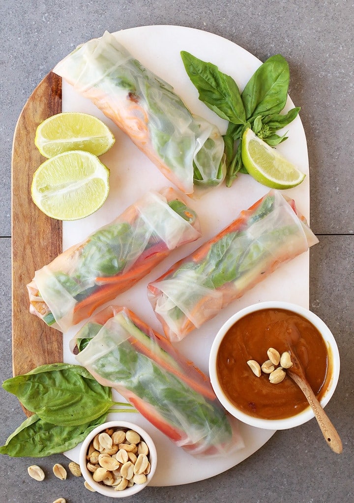 Finished spring rolls on a platter with peanut sauce