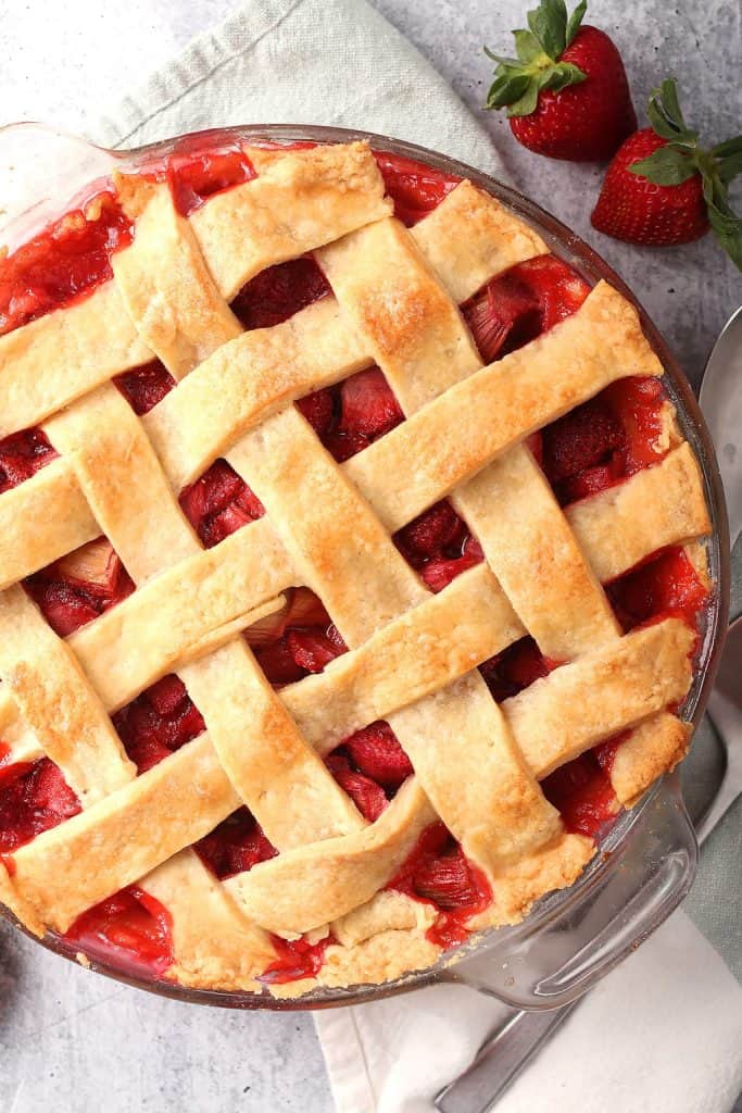 Whole strawberry rhubarb pie with a lattice top