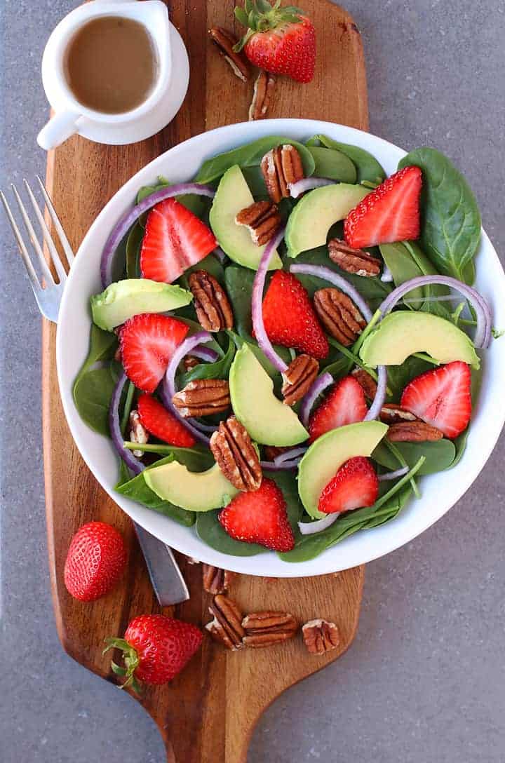 Spinach Strawberry Salad on a wooden platter