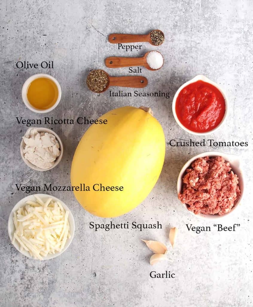 Ingredients for stuffed spaghetti squash on a concrete countertop