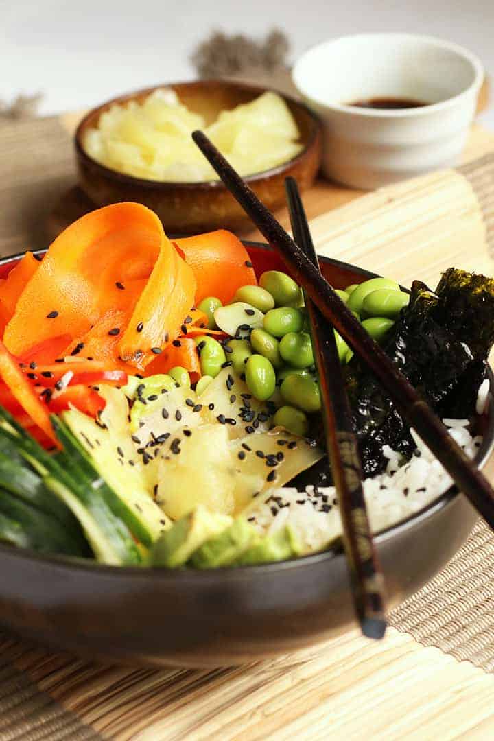 Vegan Sushi Bowl in a black bowl with chopsticks