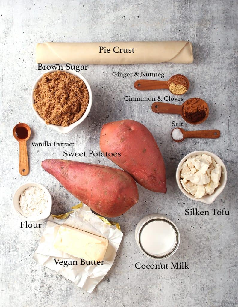 Ingredients for sweet potato pie on a concrete countertop