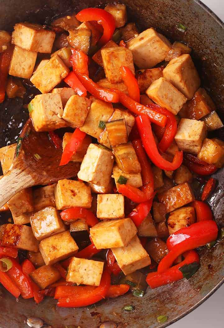 Cubed tofu and bell peppers in a skillet