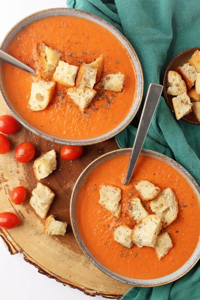 Finished soup in two bowls served with croutons