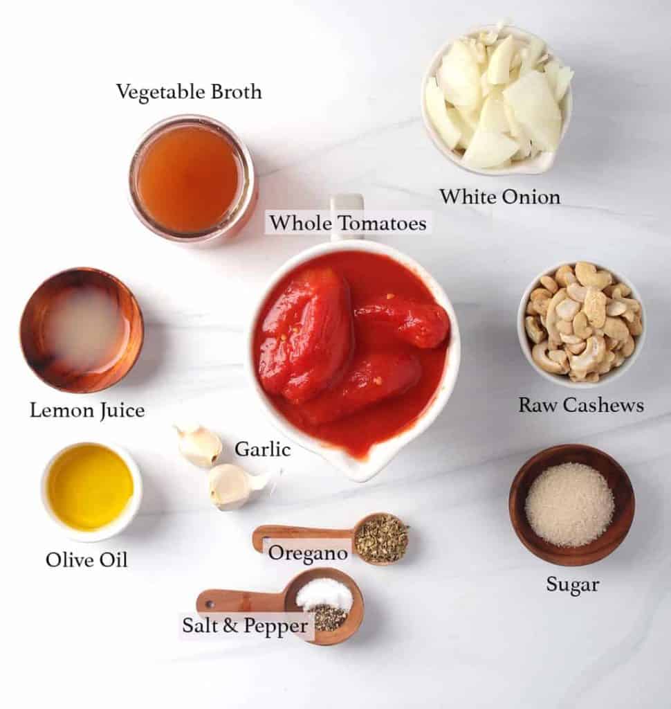 Ingredients for vegan tomato soup on a marble background. 