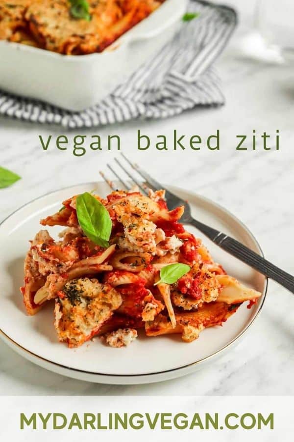 baked ziti recipe on white plate with fork and basil with "vegan baked ziti" text for Pinterest